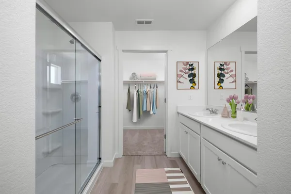 a hallway with sink and cabinets