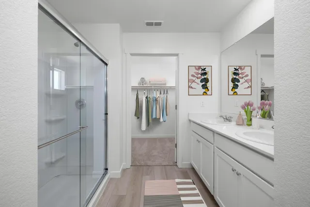 a hallway with sink and cabinets