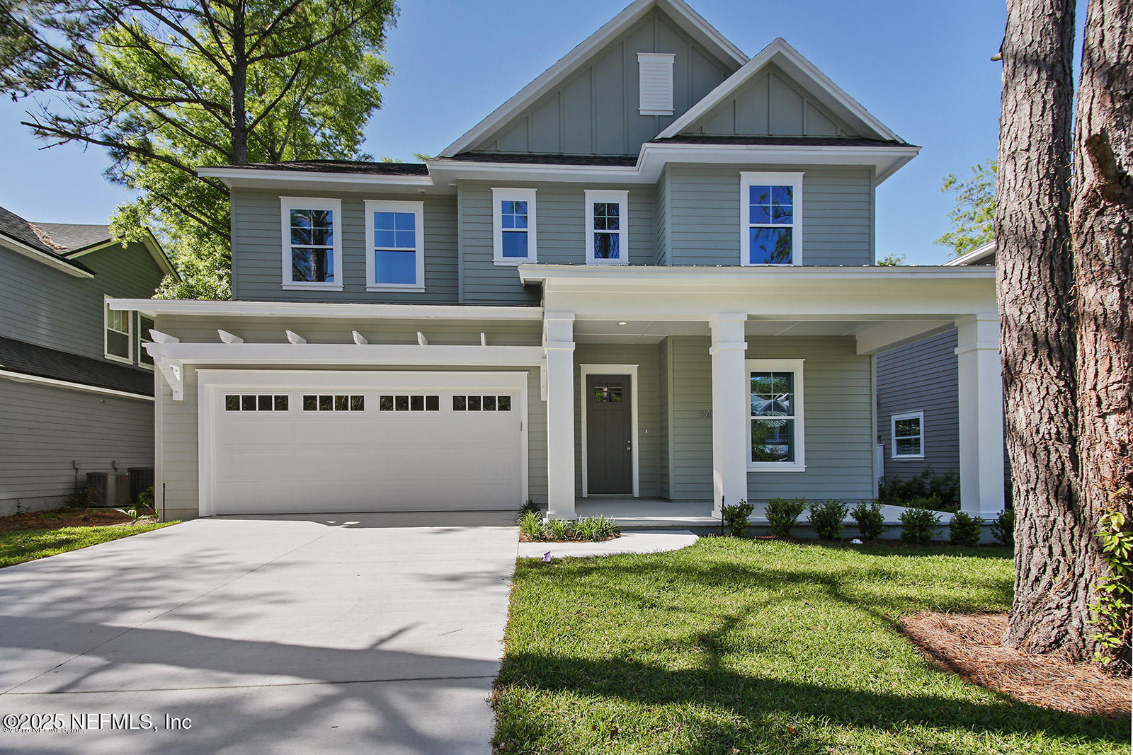 740 Paradise Lane Atlantic Beach, FL 32233 - Photo 1 of 38 a front view of a house with a yard and garage