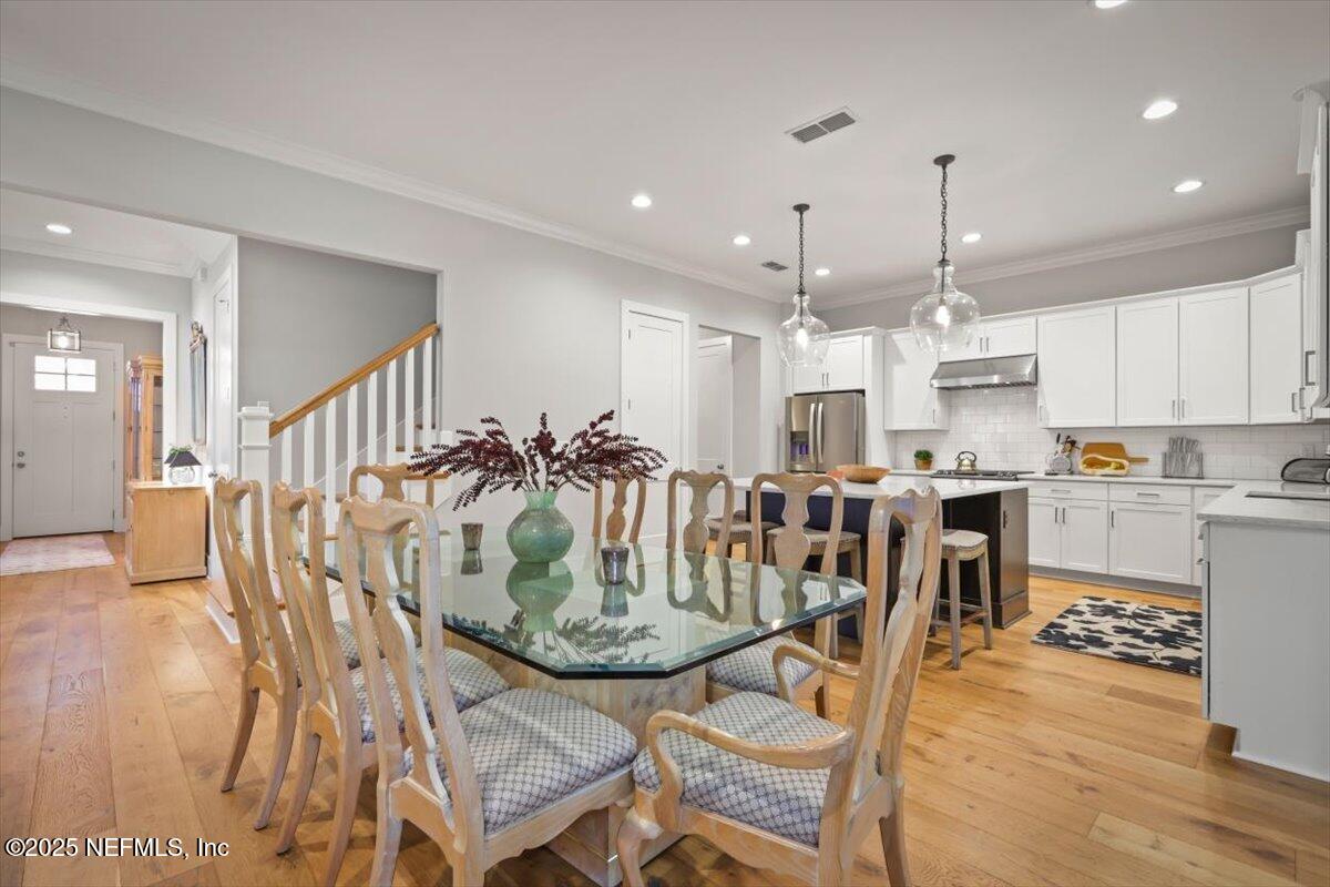 740 Paradise Lane Atlantic Beach, FL 32233 - Photo 12 of 38 a view of a dining room and livingroom with furniture wooden floor a chandelier