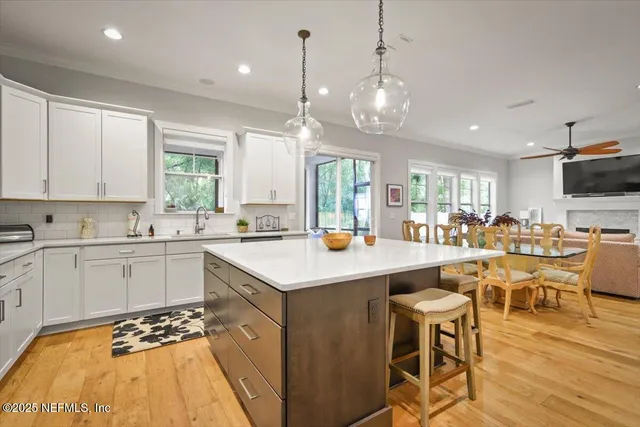 a kitchen with stainless steel appliances a stove a sink and cabinets