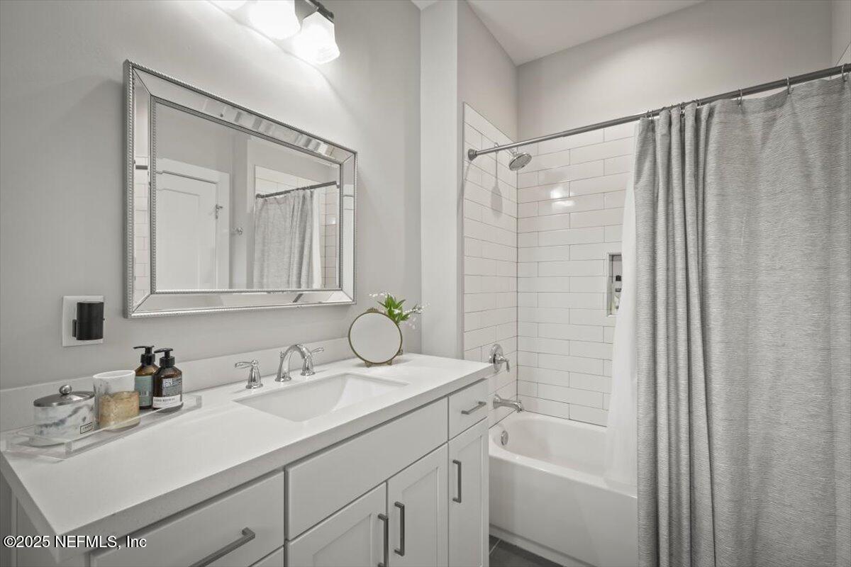740 Paradise Lane Atlantic Beach, FL 32233 - Photo 27 of 38 a bathroom with a sink double vanity granite tub shower and a mirror