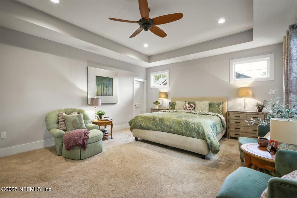 740 Paradise Lane Atlantic Beach, FL 32233 - Photo 30 of 38 a bedroom with a bed a couch and a chandelier