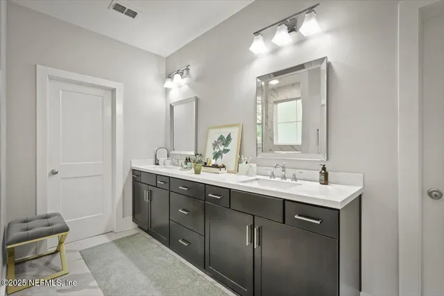 a bed sitting in a spacious bedroom next to a window