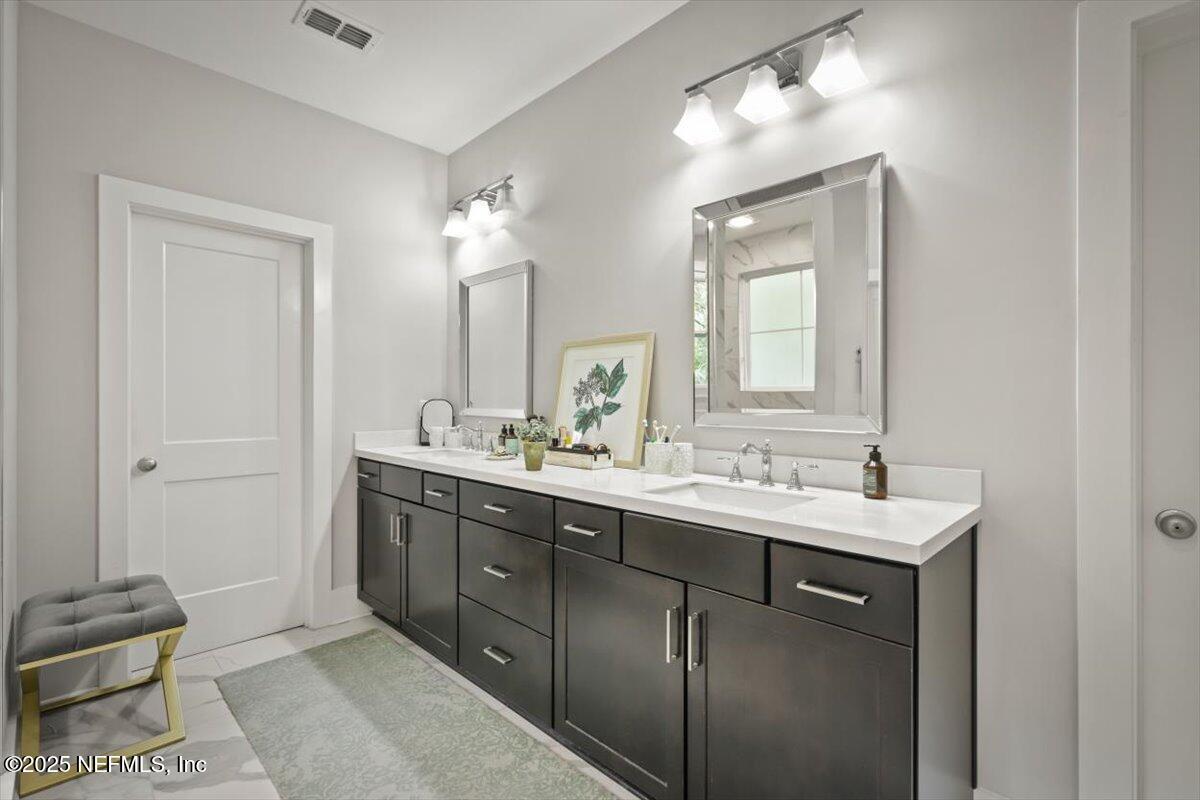 740 Paradise Lane Atlantic Beach, FL 32233 - Photo 31 of 38 a bathroom with a double vanity sink and a mirror