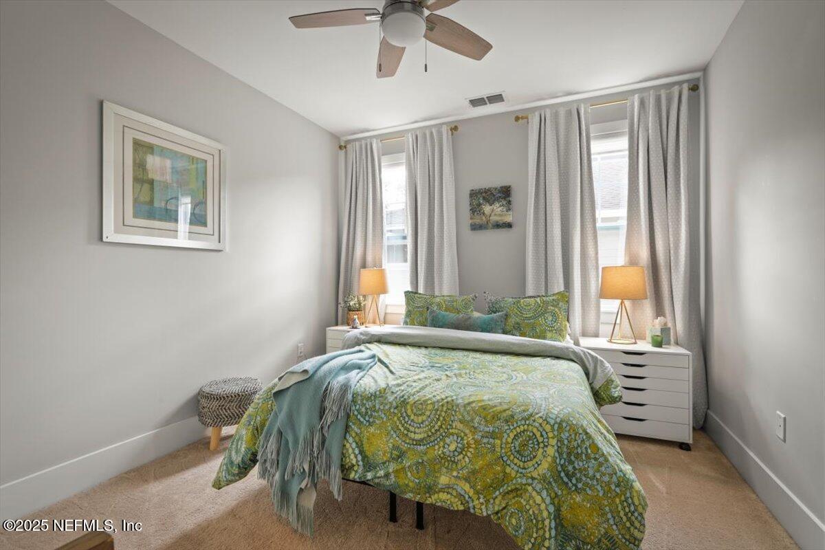 740 Paradise Lane Atlantic Beach, FL 32233 - Photo 34 of 38 a bed sitting in a spacious bedroom next to a window