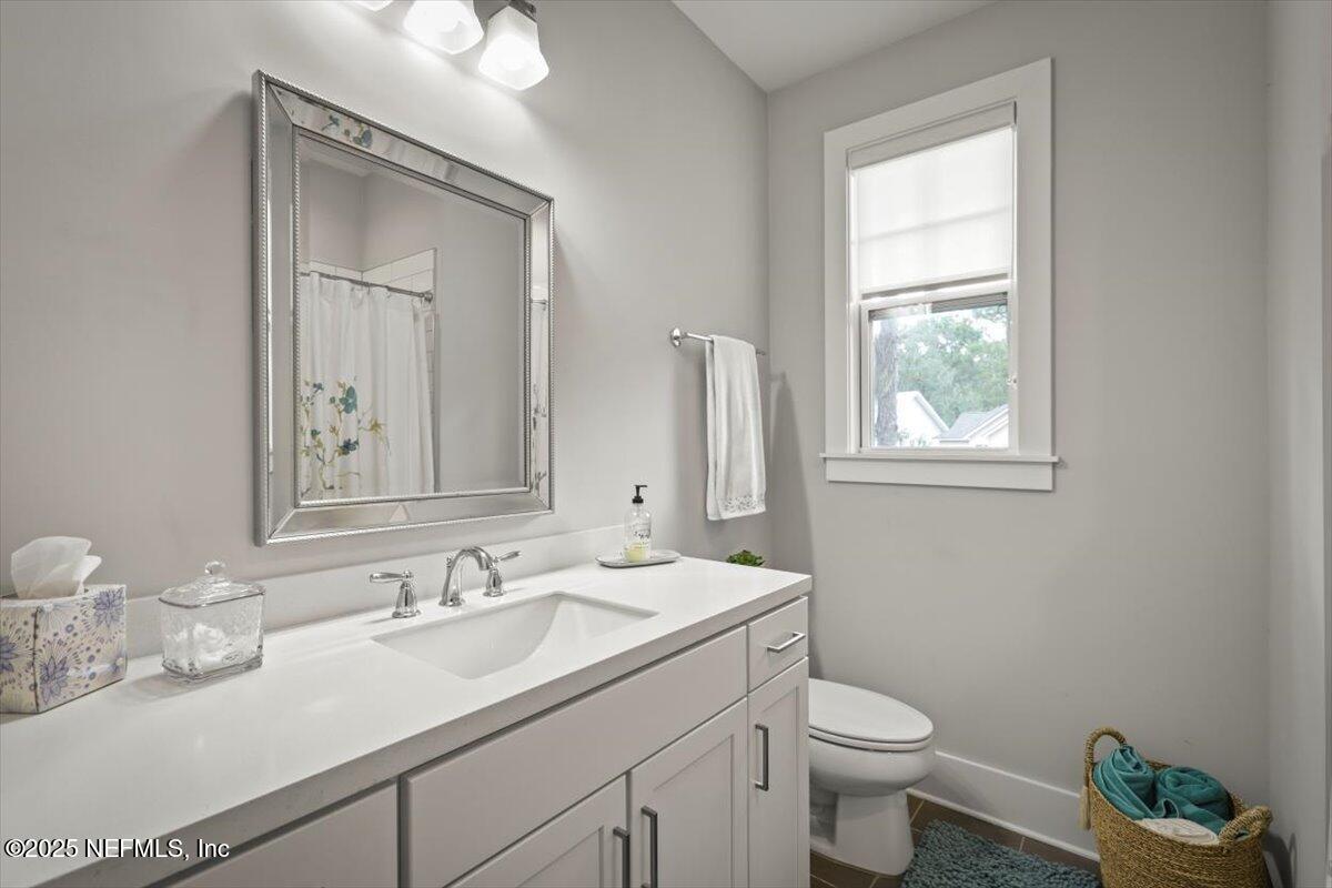 740 Paradise Lane Atlantic Beach, FL 32233 - Photo 35 of 38 a bathroom with a toilet sink and mirror
