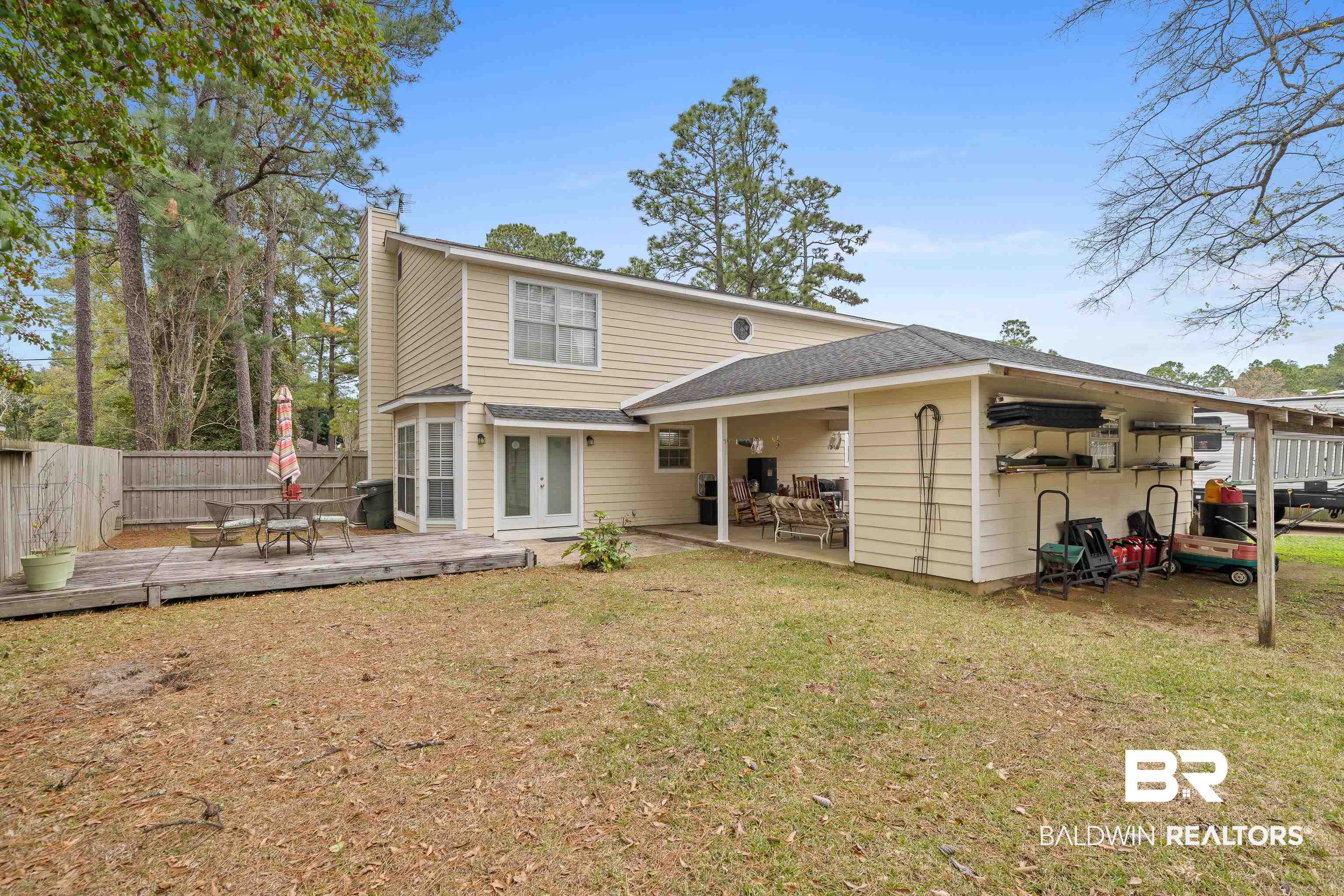 460 Ridgewood Drive Daphne, AL 36526 - Photo 25 of 31 Rear view of house featuring a wooden deck, a yard, and french doors