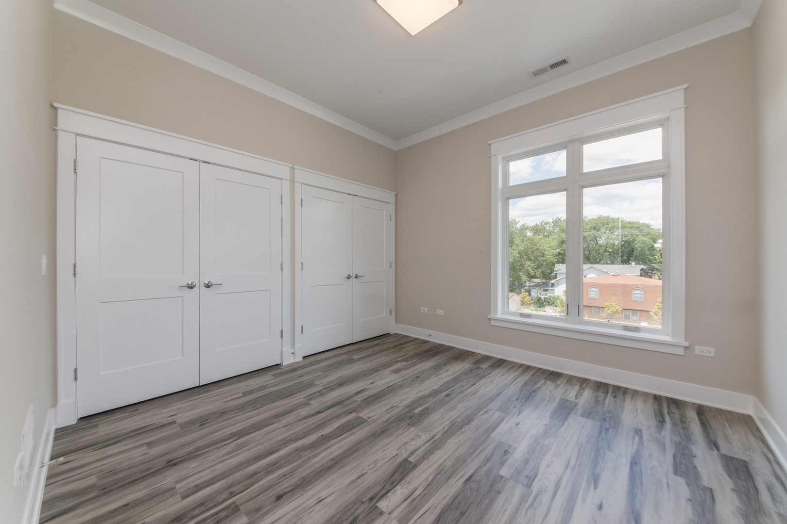 1116 Courtland Avenue, Unit 203 Park Ridge, IL 60068 - Photo 12 of 16 an empty room with wooden floor and windows