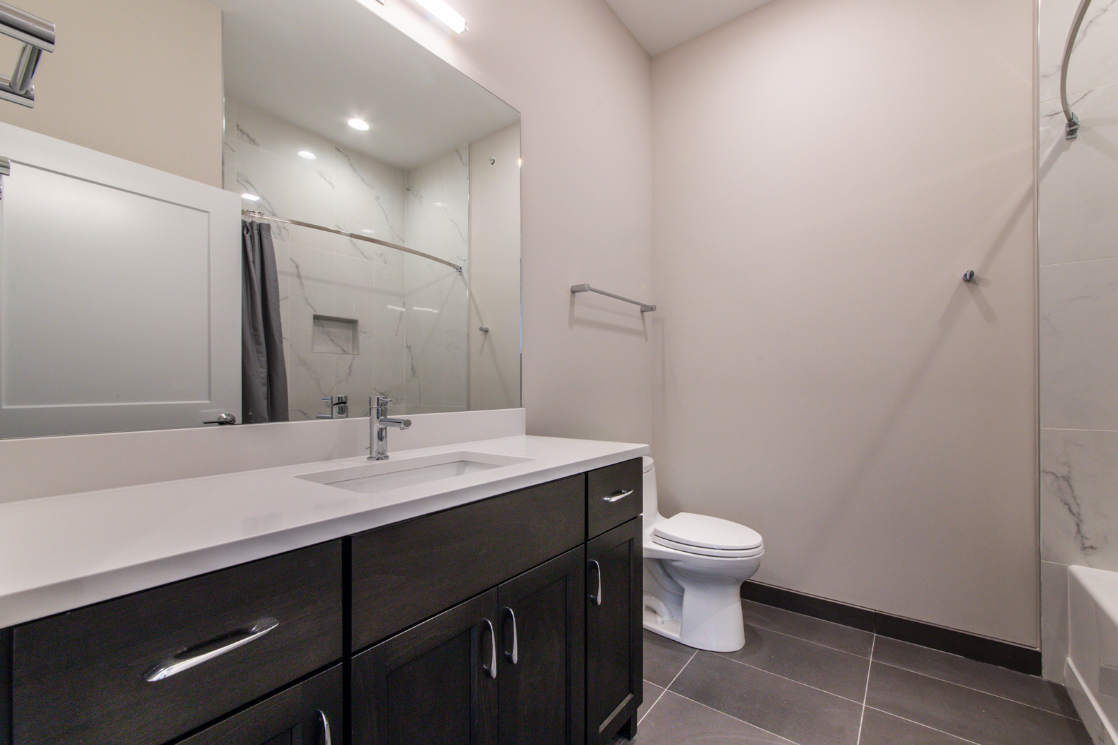 1116 Courtland Avenue, Unit 203 Park Ridge, IL 60068 - Photo 13 of 16 a bathroom with a sink a toilet a mirror and vanity