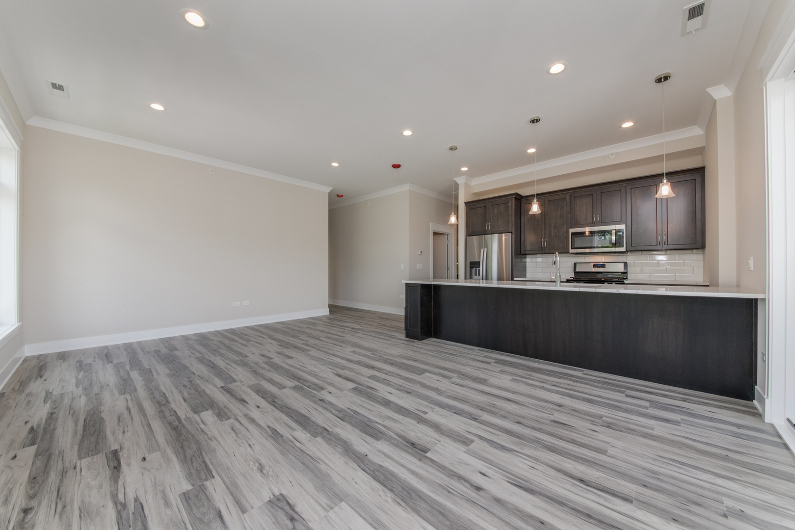 1116 Courtland Avenue, Unit 203 Park Ridge, IL 60068 - Photo 3 of 16 a large kitchen with stainless steel appliances granite countertop a large counter top and a wooden floor
