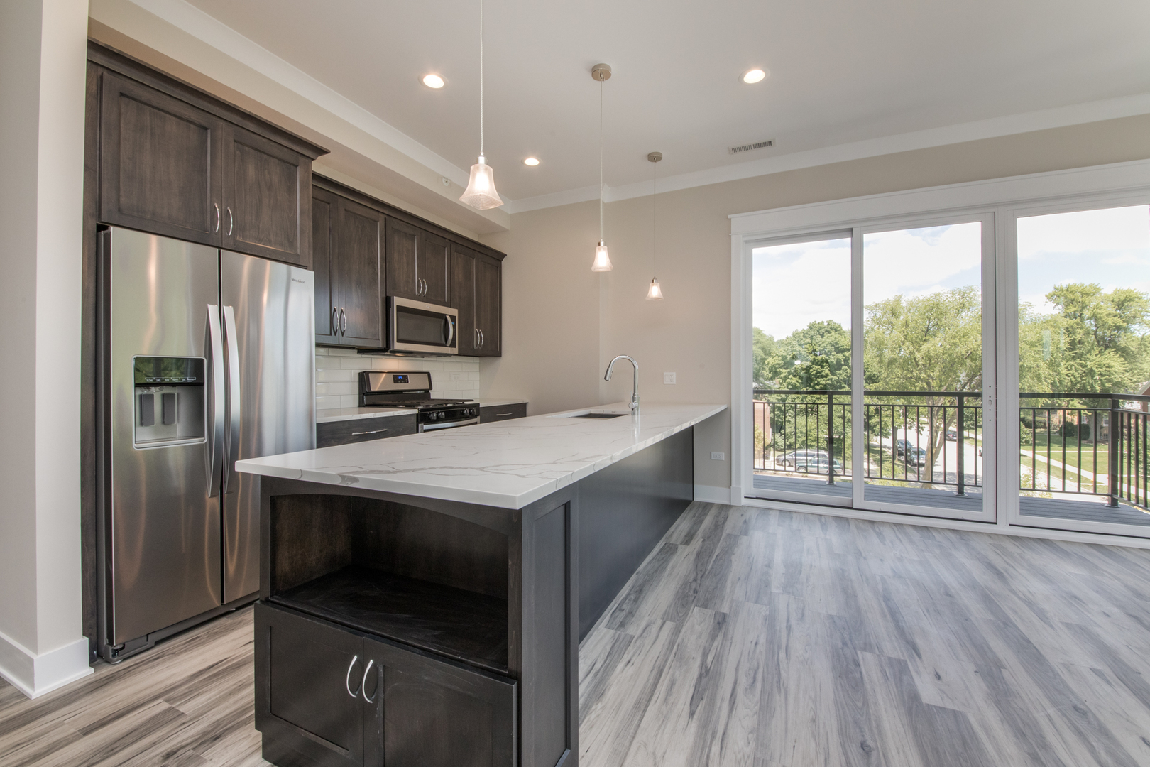 1116 Courtland Avenue, Unit 203 Park Ridge, IL 60068 - Photo 4 of 16 a kitchen with kitchen island a sink appliances and cabinets