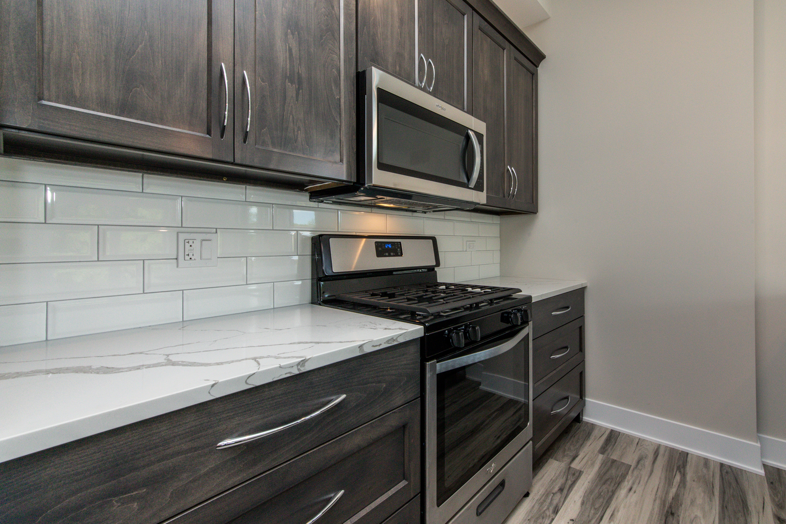 1116 Courtland Avenue, Unit 203 Park Ridge, IL 60068 - Photo 6 of 16 a kitchen with granite countertop cabinets stove top oven and microwave