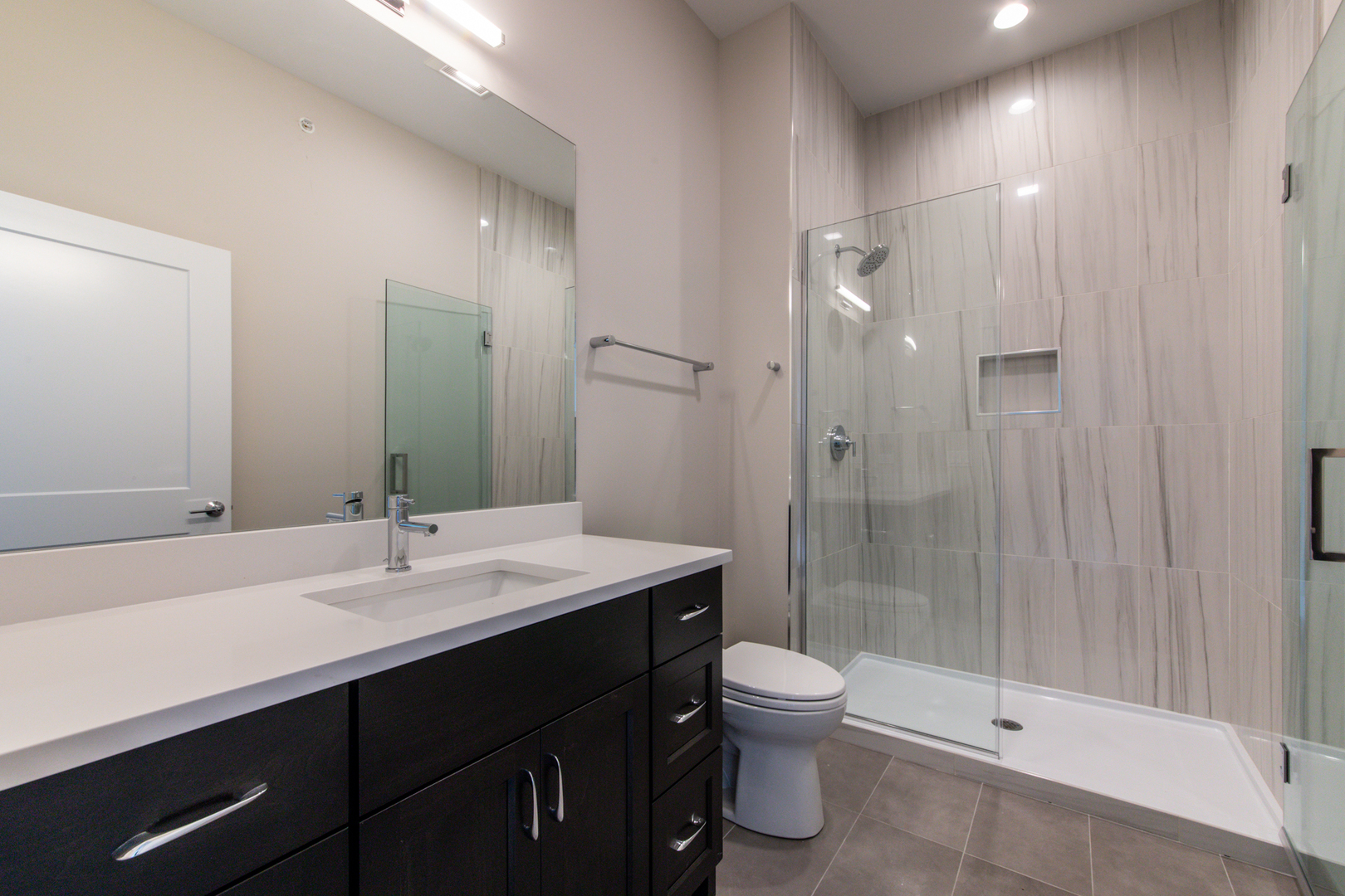 1116 Courtland Avenue, Unit 203 Park Ridge, IL 60068 - Photo 8 of 16 a bathroom with a sink shower and a toilet