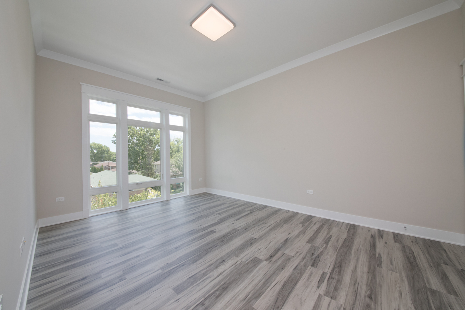 1116 Courtland Avenue, Unit 203 Park Ridge, IL 60068 - Photo 10 of 16 a view of an empty room with wooden floor and a window