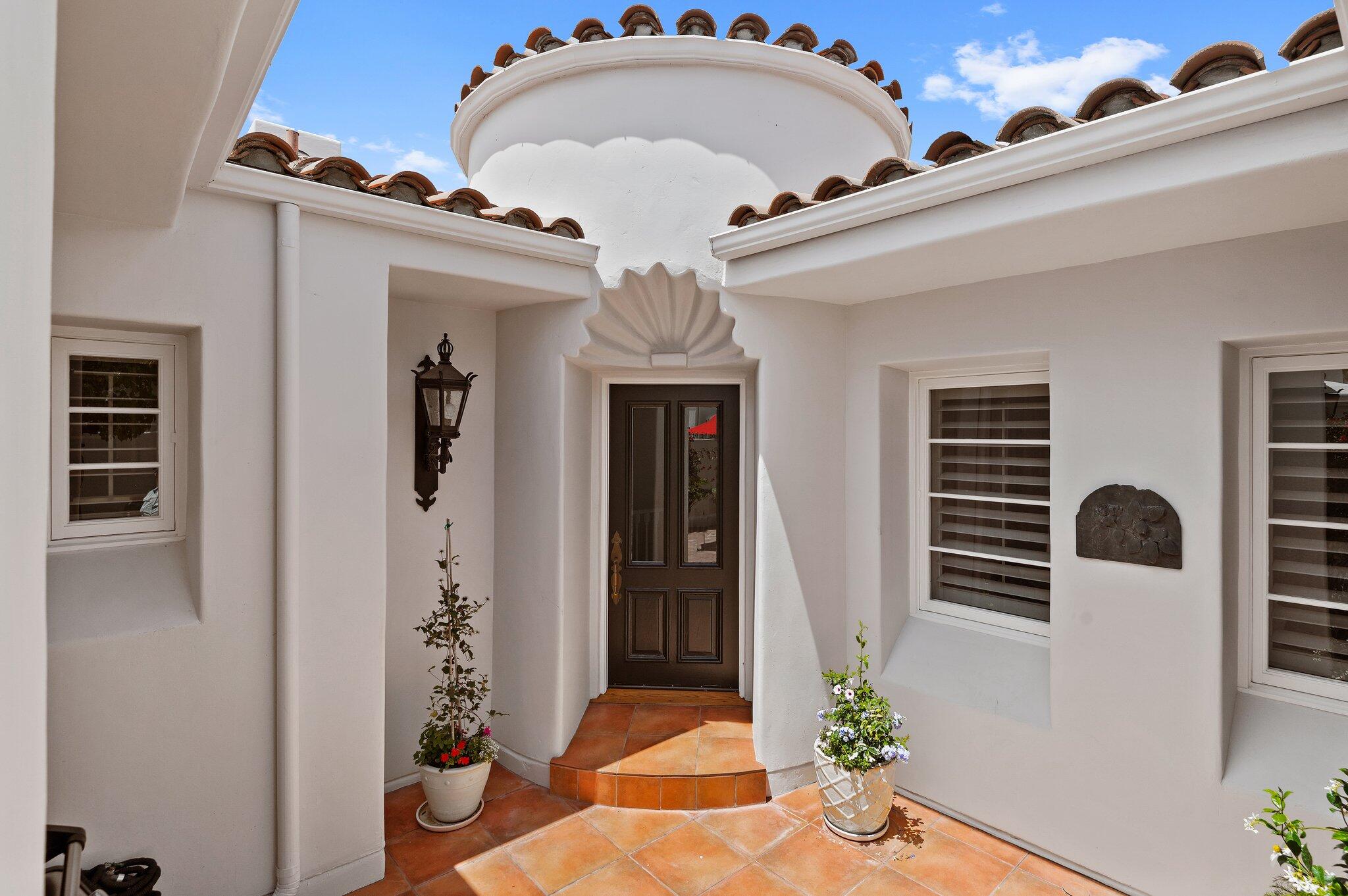 a view of hall way with mirror and furniture