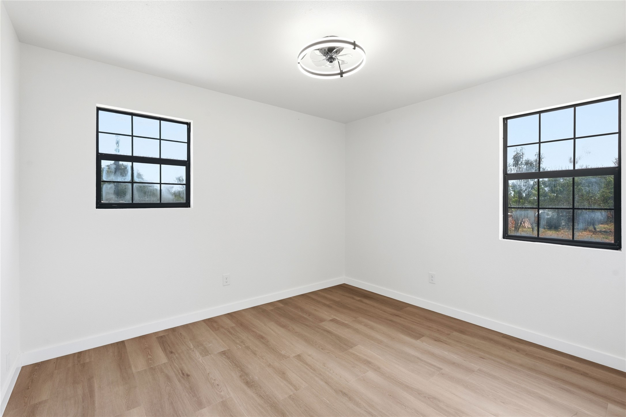 747 Chamberlin Road Dale, TX 78616 - Photo 15 of 28 Vinyl plank flooring complements the modern ceiling light and provides a clean canvas for your personal touch.