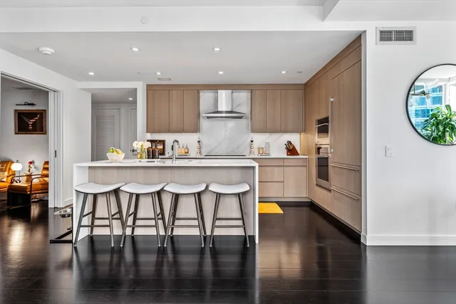 a kitchen with a table chairs refrigerator and microwave