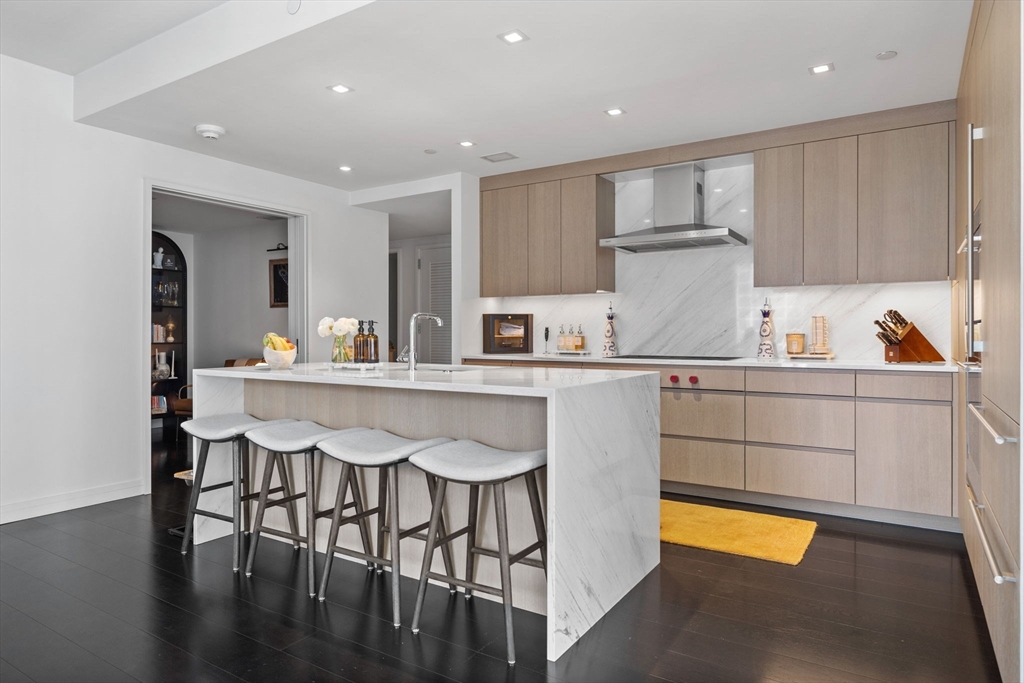 150 Seaport Boulevard, Unit 14B Boston, MA 02210 - Photo 12 of 42 a kitchen with a sink a stove a refrigerator and cabinets
