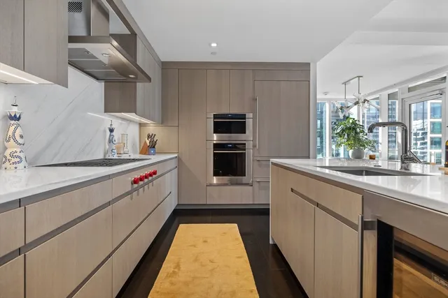 a kitchen with stainless steel appliances a sink and a refrigerator