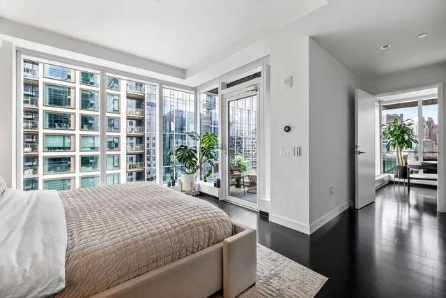 a bedroom with a large bed and a large window