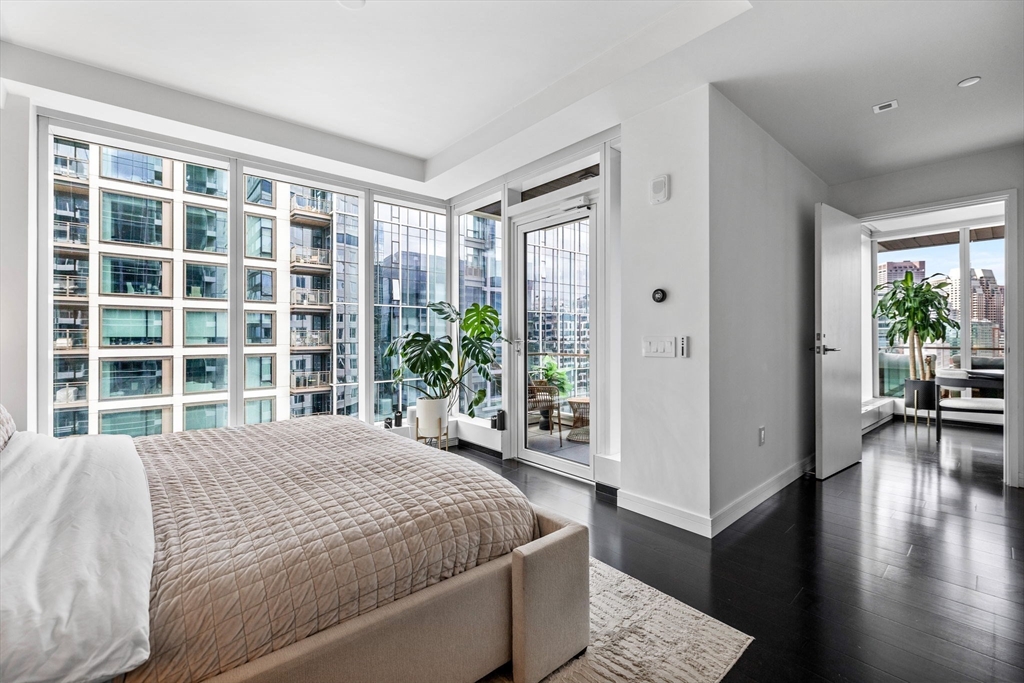 150 Seaport Boulevard, Unit 14B Boston, MA 02210 - Photo 16 of 42 a bedroom with a large bed and a large window