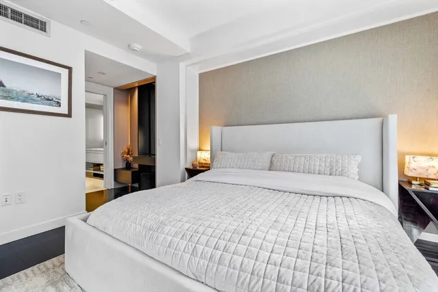 a bedroom with a large bed and a dresser