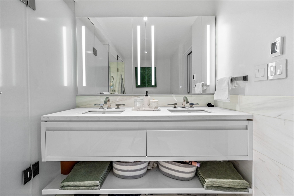 150 Seaport Boulevard, Unit 14B Boston, MA 02210 - Photo 24 of 42 a bathroom with a sink and a mirror