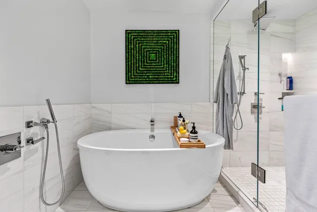 a white bath tub sitting next to a bathroom