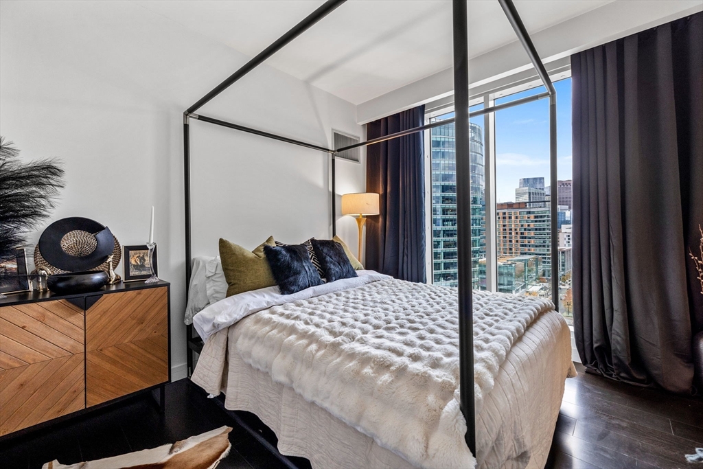 150 Seaport Boulevard, Unit 14B Boston, MA 02210 - Photo 27 of 42 a bedroom with a bed and a large window