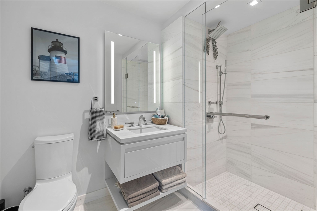 150 Seaport Boulevard, Unit 14B Boston, MA 02210 - Photo 32 of 42 a bathroom with a toilet sink and shower