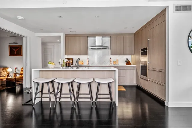 a kitchen with a table chairs microwave and cabinets