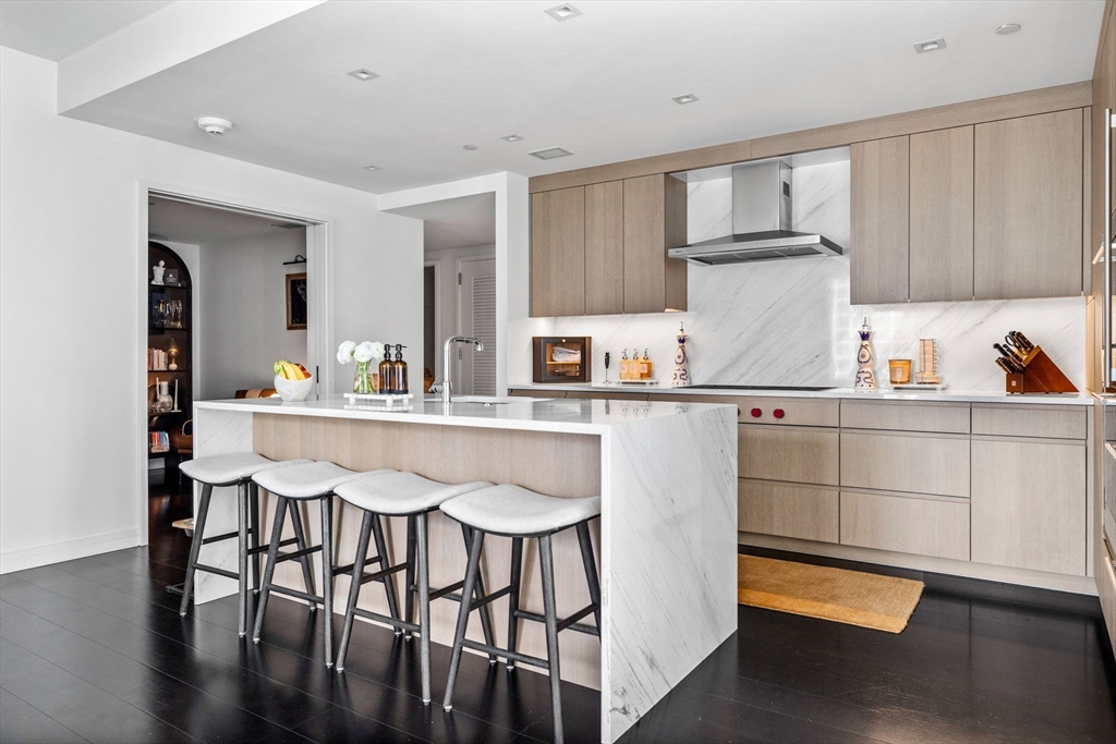 150 Seaport Boulevard, Unit 14B Boston, MA 02210 - Photo 9 of 42 a kitchen with stainless steel appliances granite countertop a sink and cabinets