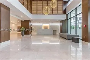 a view of a lobby with furniture and a potted plant