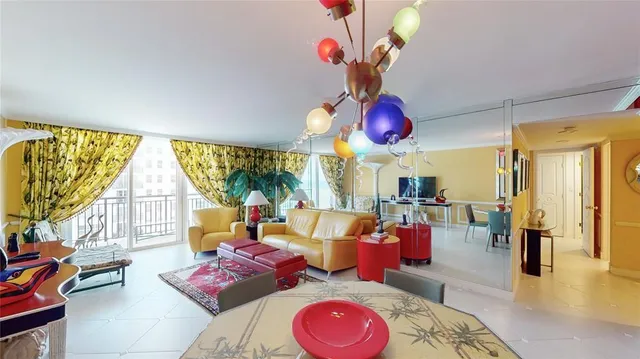 a living room with furniture fireplace and a large window