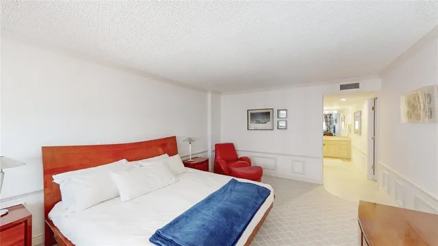 a bedroom with a bed and a couch