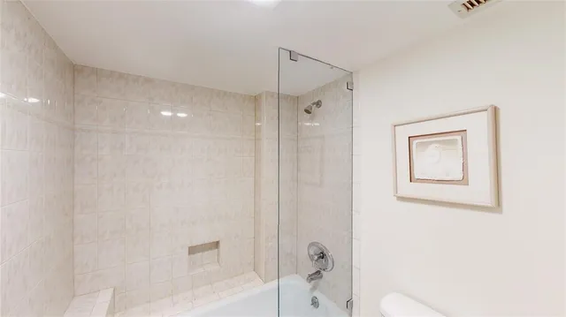 a bathroom with a shower and a toilet