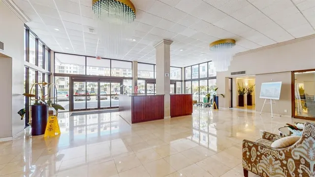 a lobby with furniture and floor to ceiling window