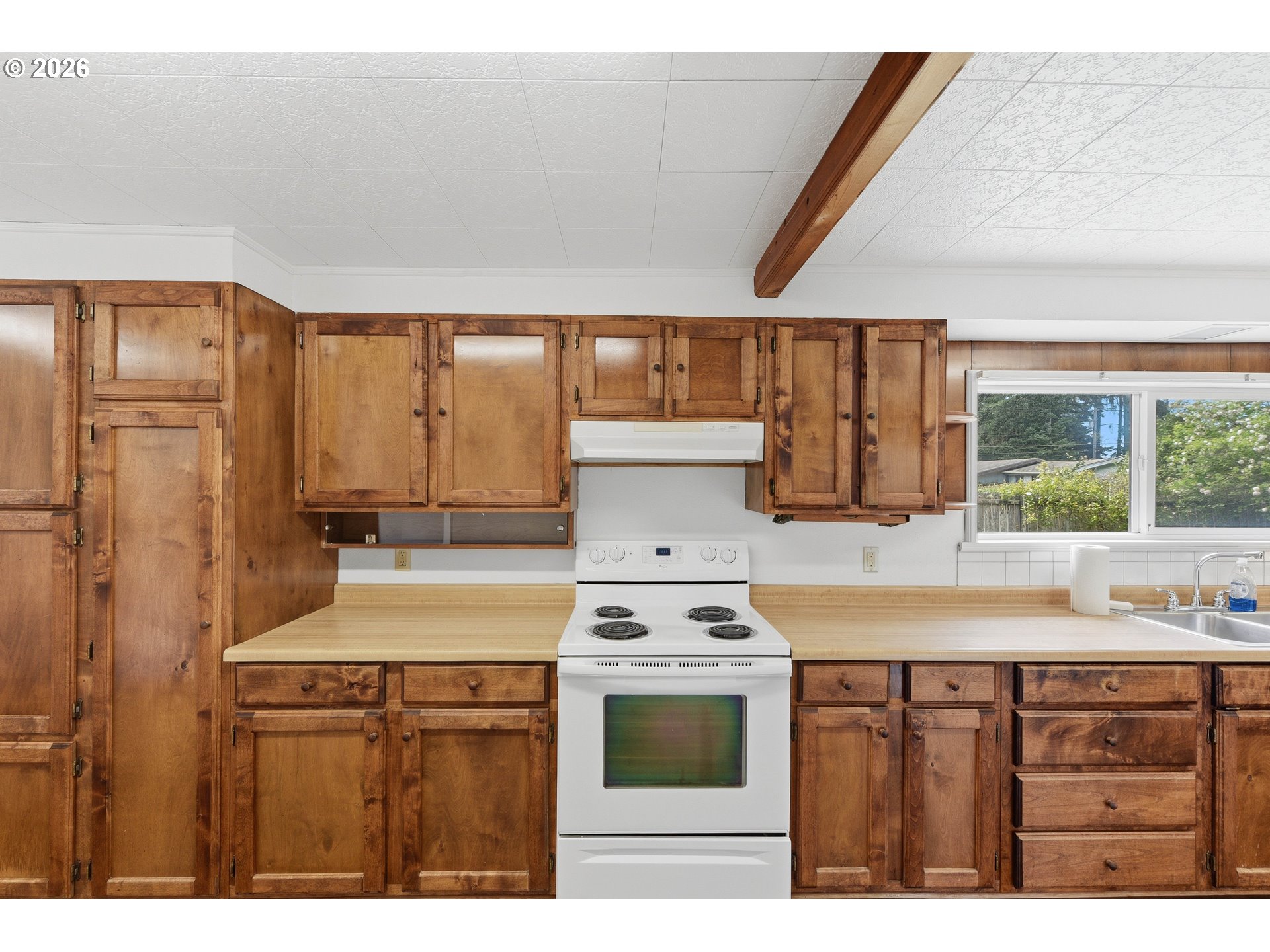 63299 Wildahl Road Coos Bay, OR 97420 - Photo 24 of 45 a kitchen with stainless steel appliances granite countertop a stove a sink and a microwave
