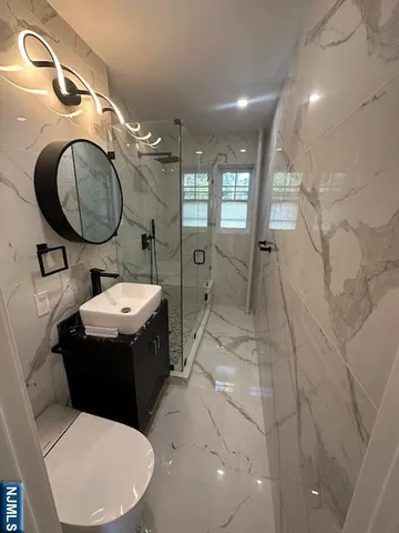 a bathroom with a toilet sink and mirror