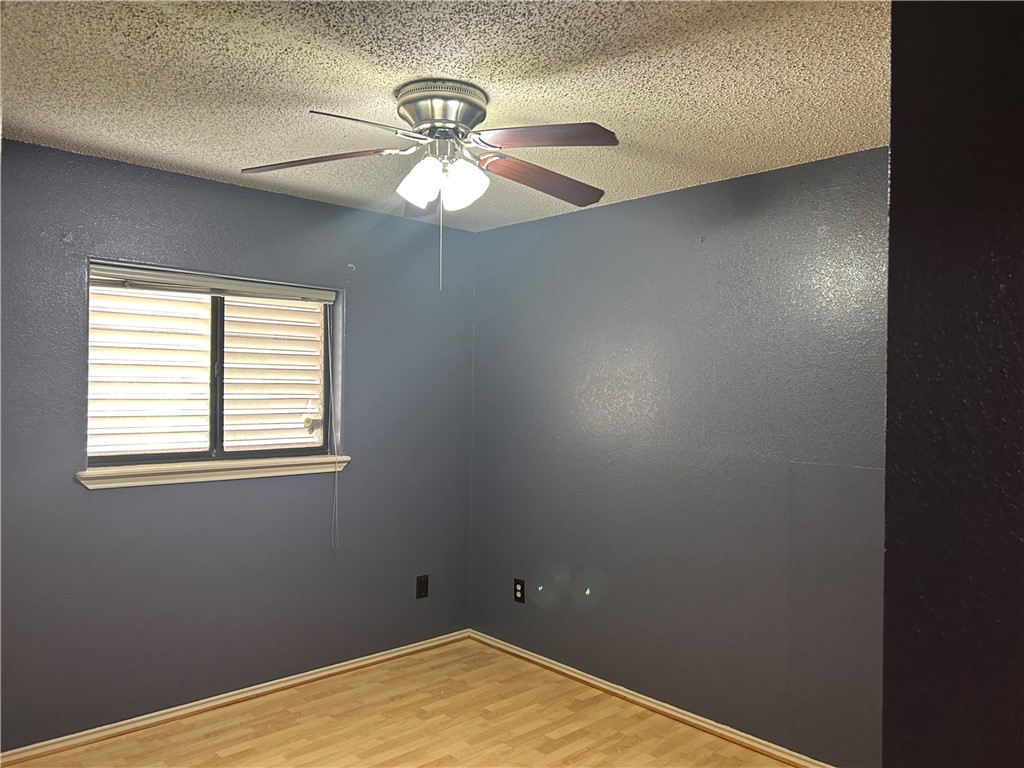 4530 Windows Drive Corpus Christi, TX 78413 - Photo 4 of 11 an empty room with a window and a fan