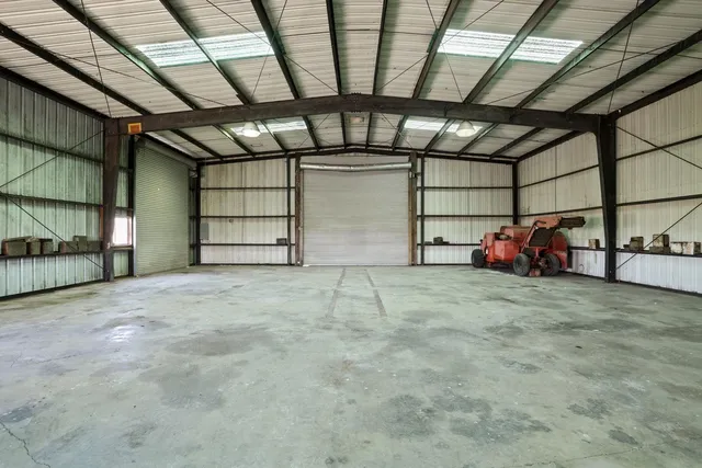 a backyard of a house with barbeque oven table and chairs