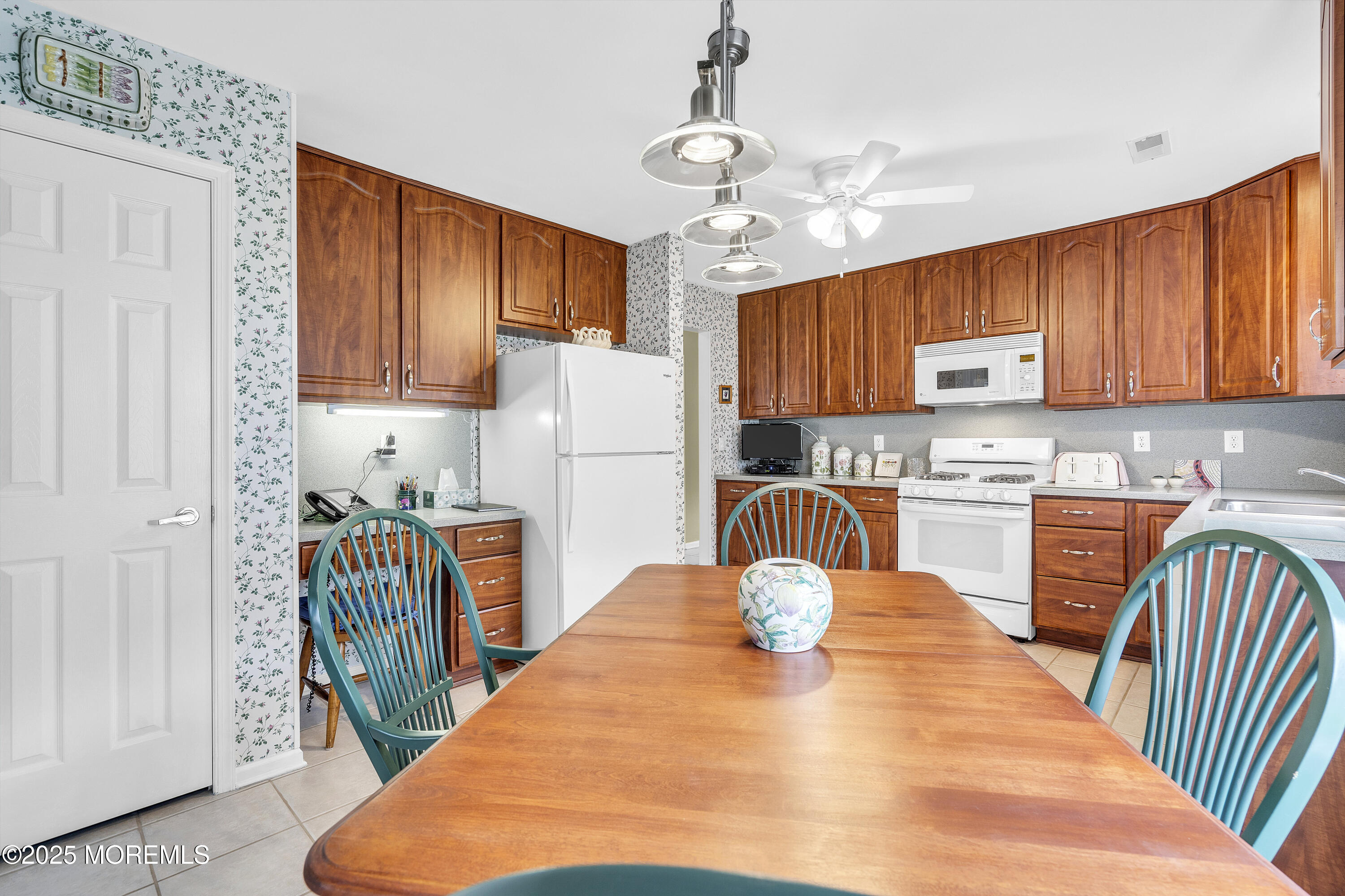 2 Seminole Court Jackson, NJ 08527 - Photo 16 of 32 a kitchen with stainless steel appliances granite countertop a refrigerator a stove top oven a sink dishwasher and wooden cabinets with wooden floor