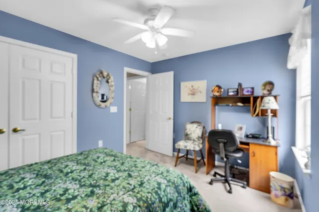 a bedroom with filled bed and a chandelier
