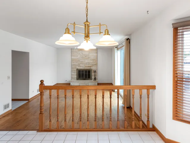 an empty room with wooden floor and fireplace