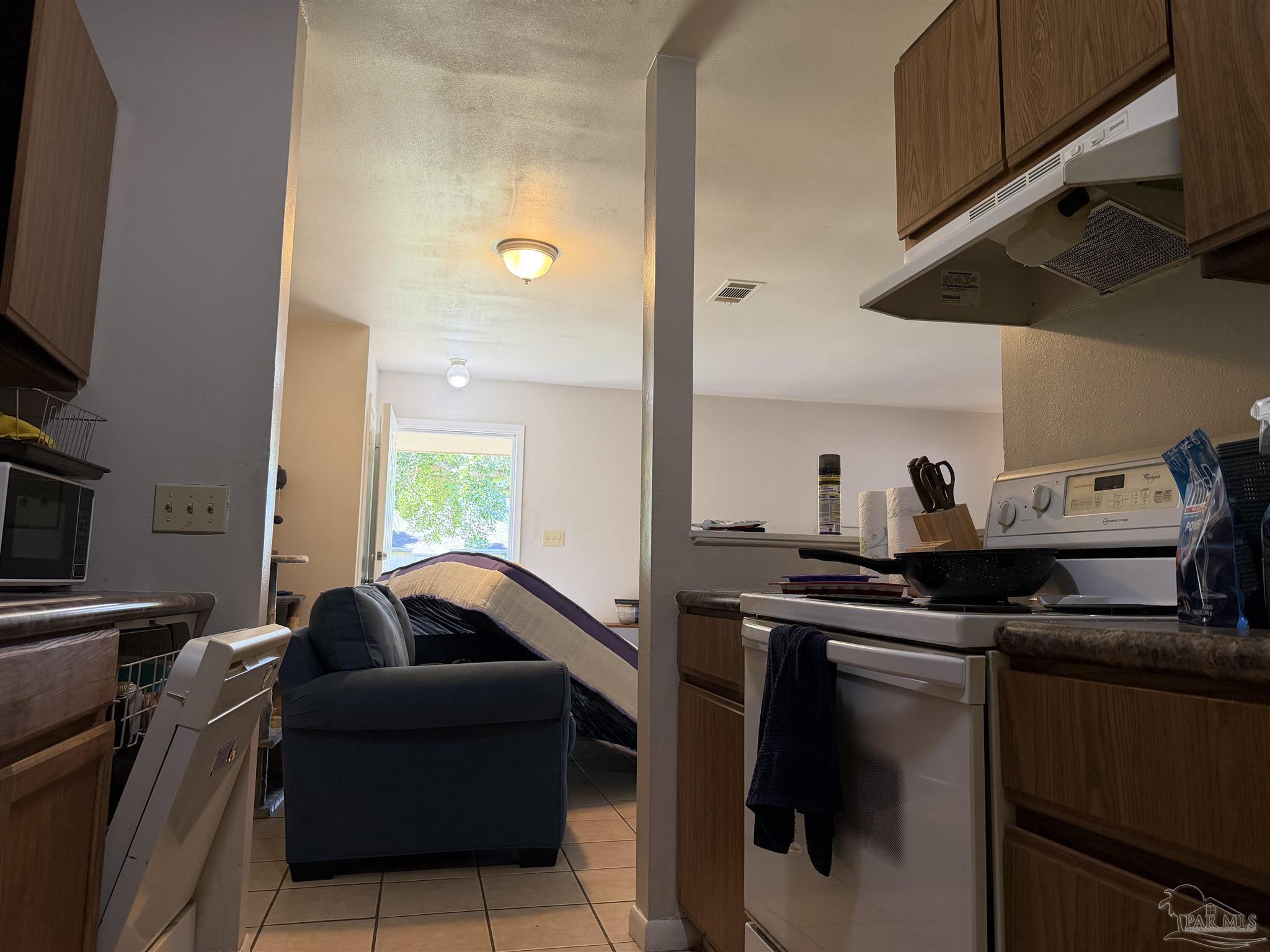 130 East 9 Mile Road, Unit 7 Pensacola, FL 32534 - Photo 13 of 61 a living room with furniture and a flat screen tv