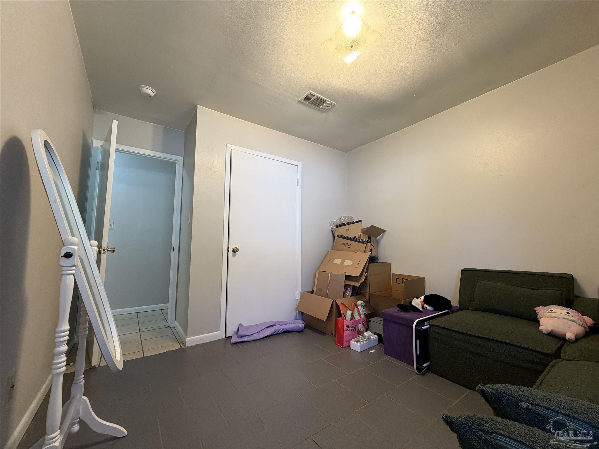 130 East 9 Mile Road, Unit 7 Pensacola, FL 32534 - Photo 14 of 61 a living room with furniture and a flat screen tv