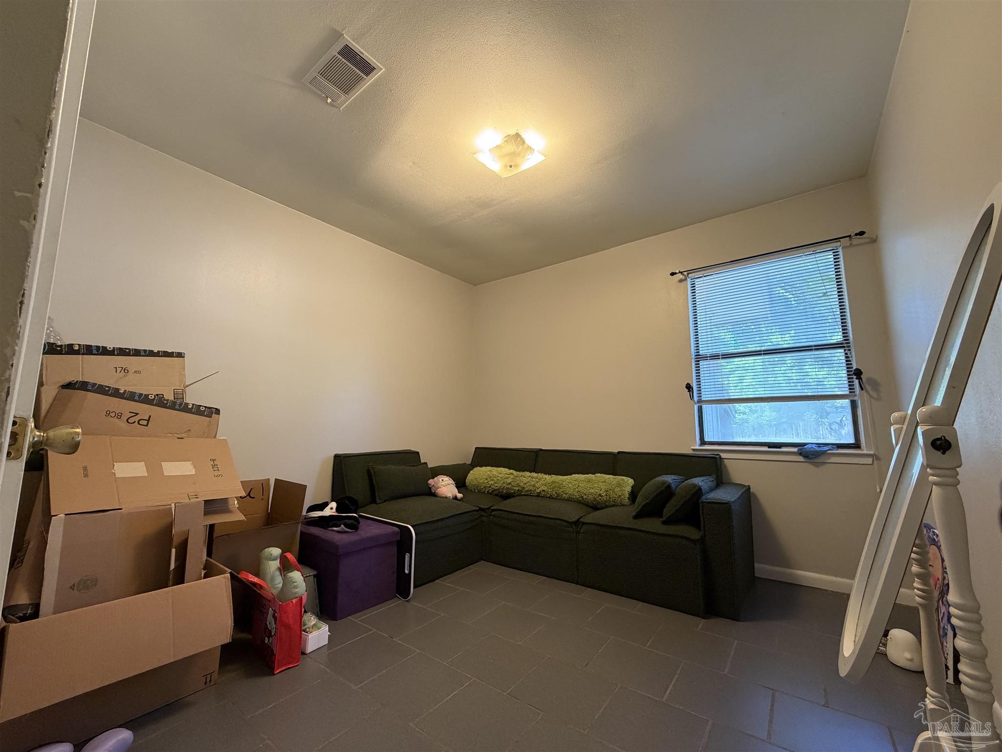 130 East 9 Mile Road, Unit 7 Pensacola, FL 32534 - Photo 15 of 61 a living room with furniture and a window