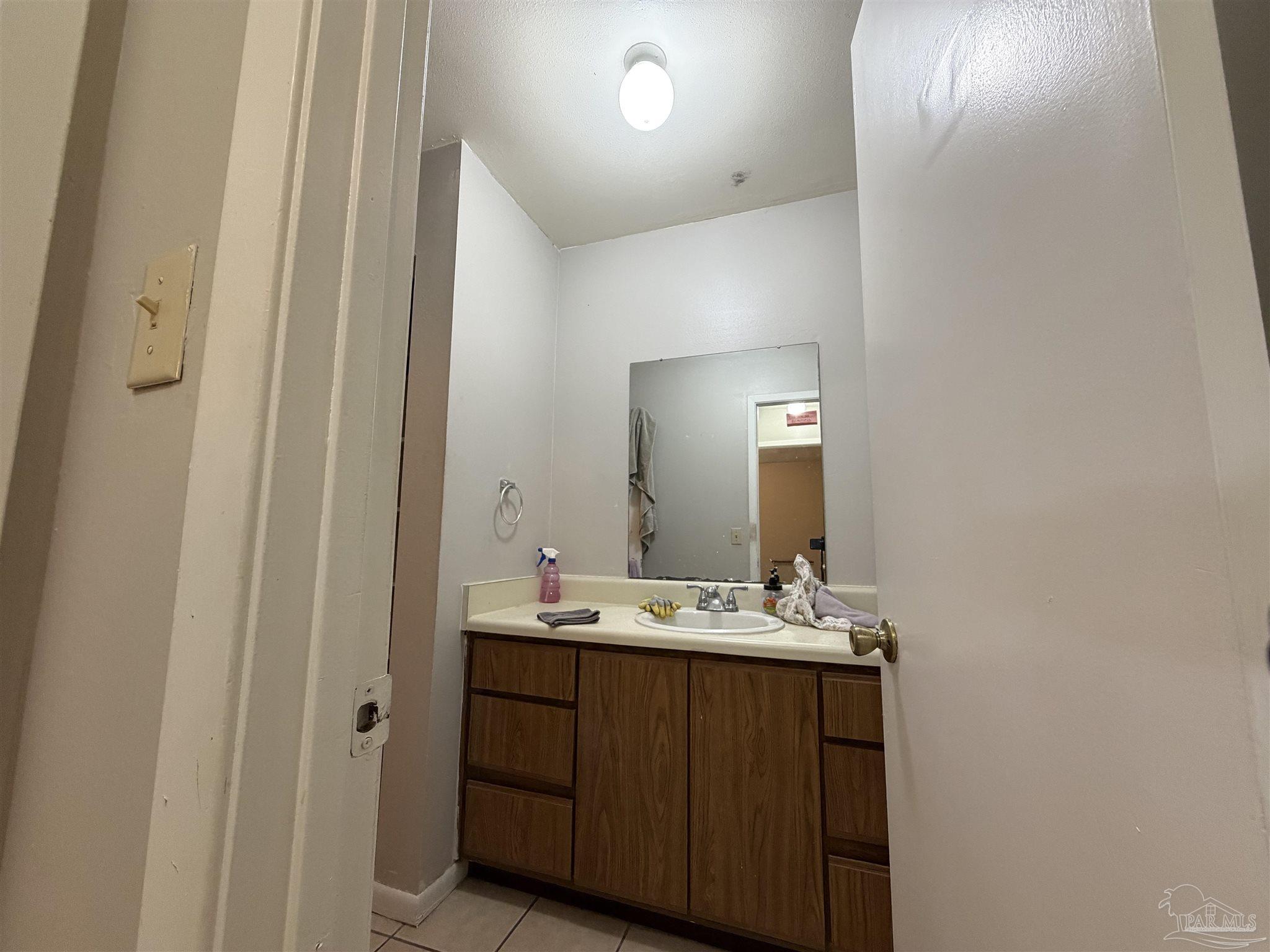 130 East 9 Mile Road, Unit 7 Pensacola, FL 32534 - Photo 18 of 61 a bathroom with a sink and a mirror