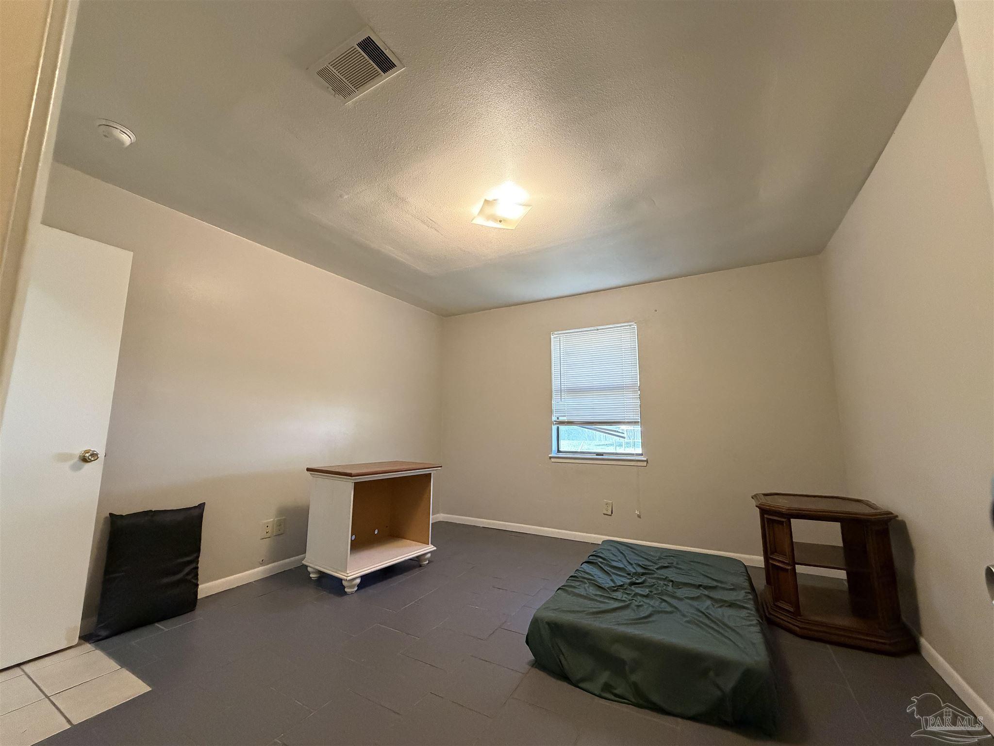 130 East 9 Mile Road, Unit 7 Pensacola, FL 32534 - Photo 23 of 61 a living room with furniture and a window